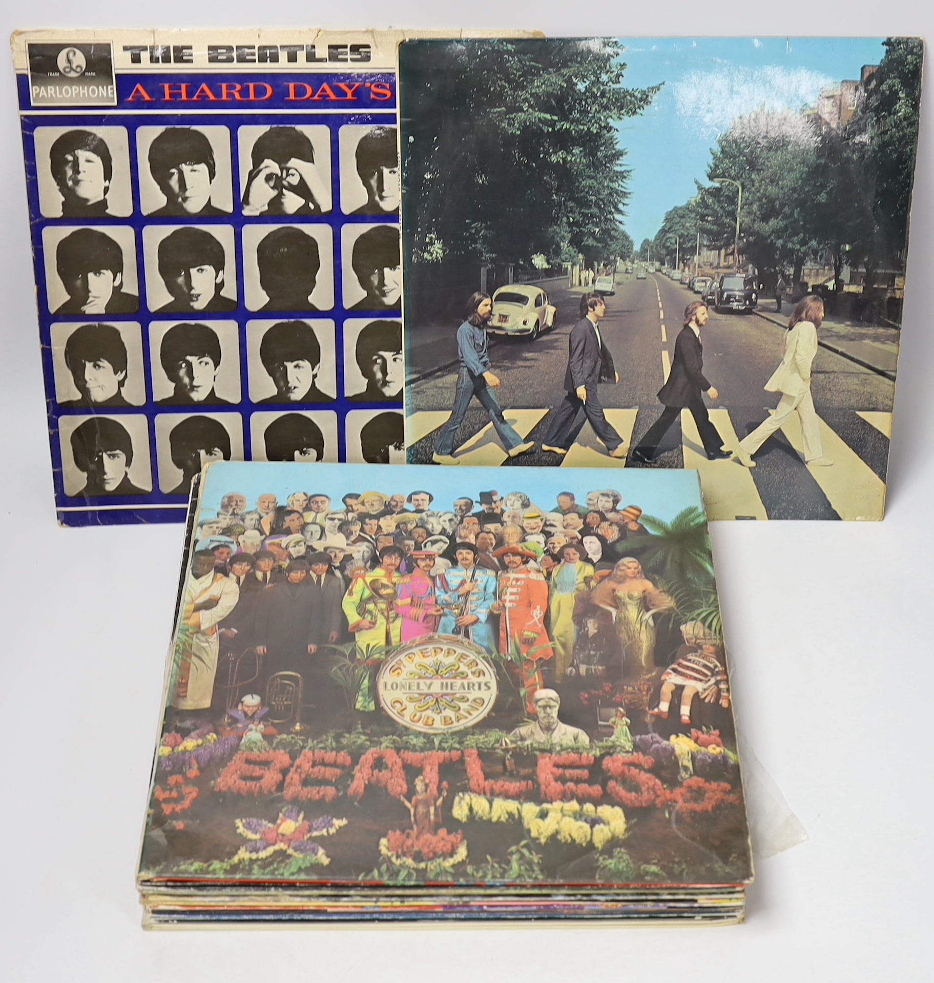 Fifteen The Beatles related albums, including, the White Album; No.0331437 (with three photo cards present), Abbey Road, Let It Be, Sgt. Pepper, and another, together with John Lennon, including Double Fantasy, Rock ‘n’